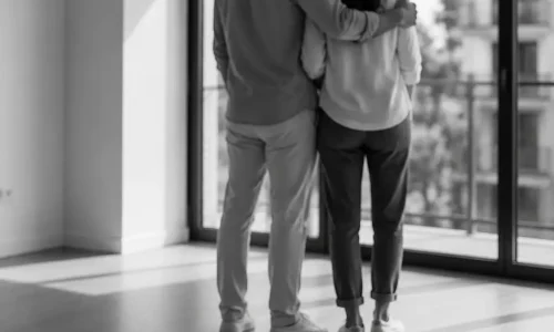 Pareja observando su primera vivienda en un espacio luminoso